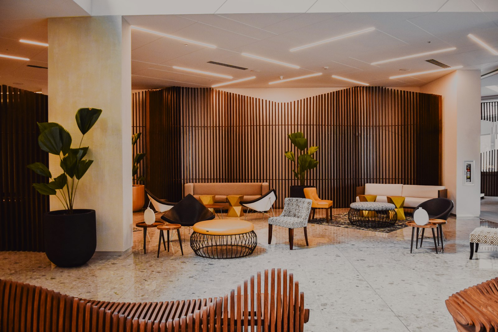Modern hotel lobby with wood-panelled walls and lounge seating. Representative image, not a client property.