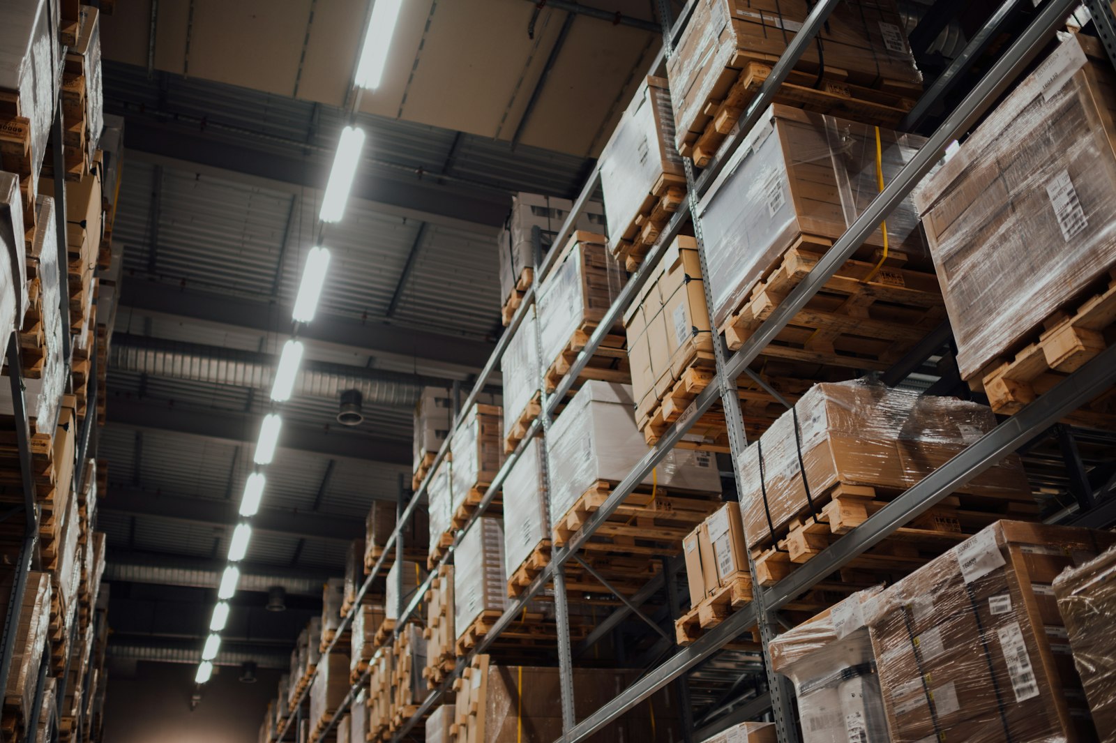 High-bay warehouse racking stacked with palleted goods. Representative image, not a client facility.